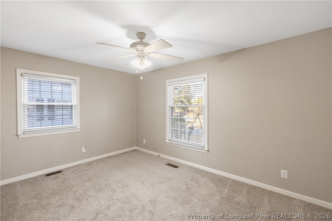2527 Huntington Road Fayetteville, NC 28303 - Photo 26 of 39 an empty room with windows and fan