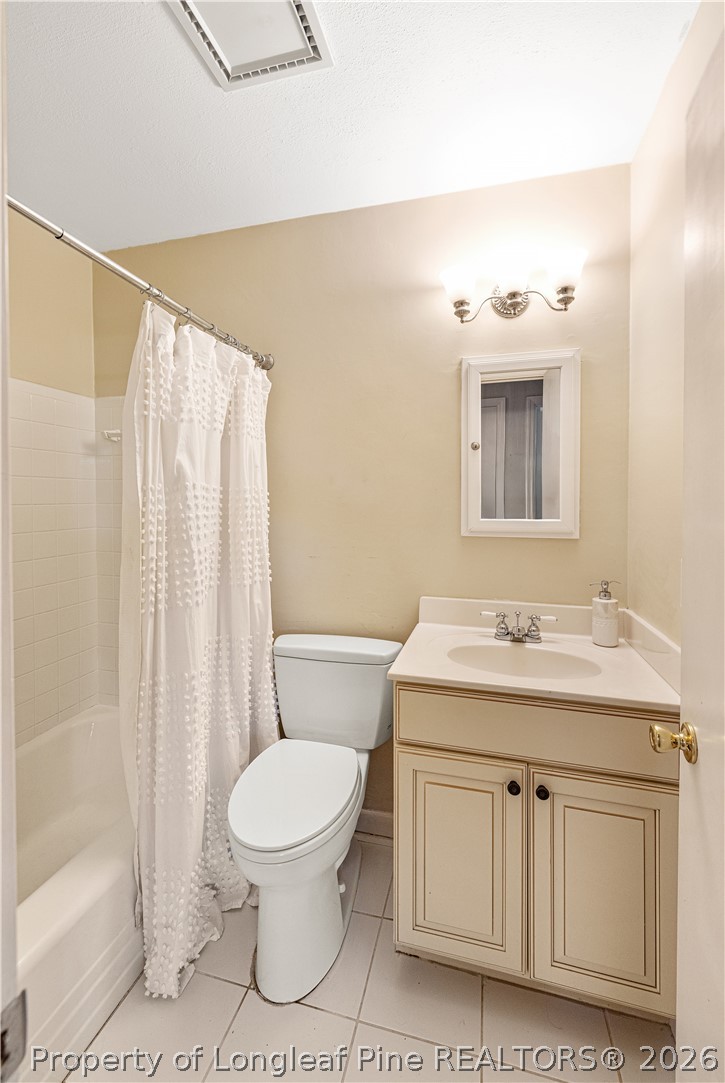 2527 Huntington Road Fayetteville, NC 28303 - Photo 28 of 39 a bathroom with a toilet a sink and a mirror