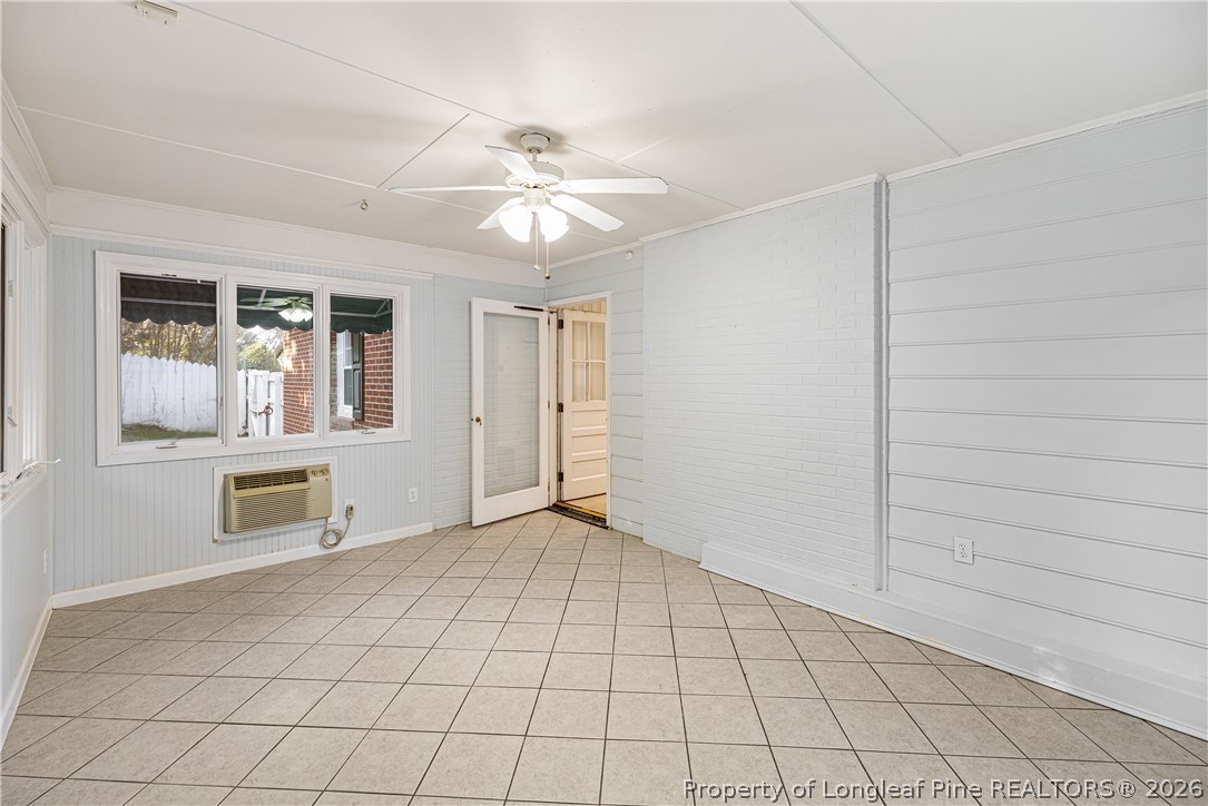 2527 Huntington Road Fayetteville, NC 28303 - Photo 33 of 39 an empty room with chandelier fan and windows
