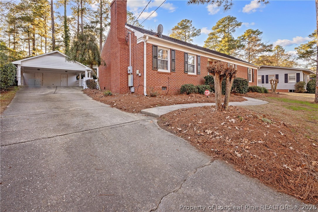 2527 Huntington Road Fayetteville, NC 28303 - Photo 36 of 39 a front view of a house with a yard and garage