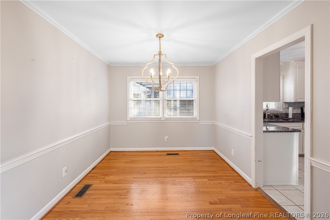 2527 Huntington Road Fayetteville, NC 28303 - Photo 8 of 39 a view of empty room with wooden floor and fan