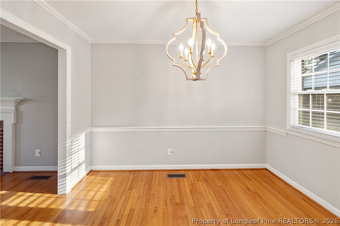 2527 Huntington Road Fayetteville, NC 28303 - Photo 9 of 39 an empty room with wooden floor and windows
