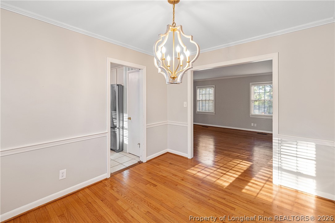 2527 Huntington Road Fayetteville, NC 28303 - Photo 10 of 39 a view of empty room with wooden floor