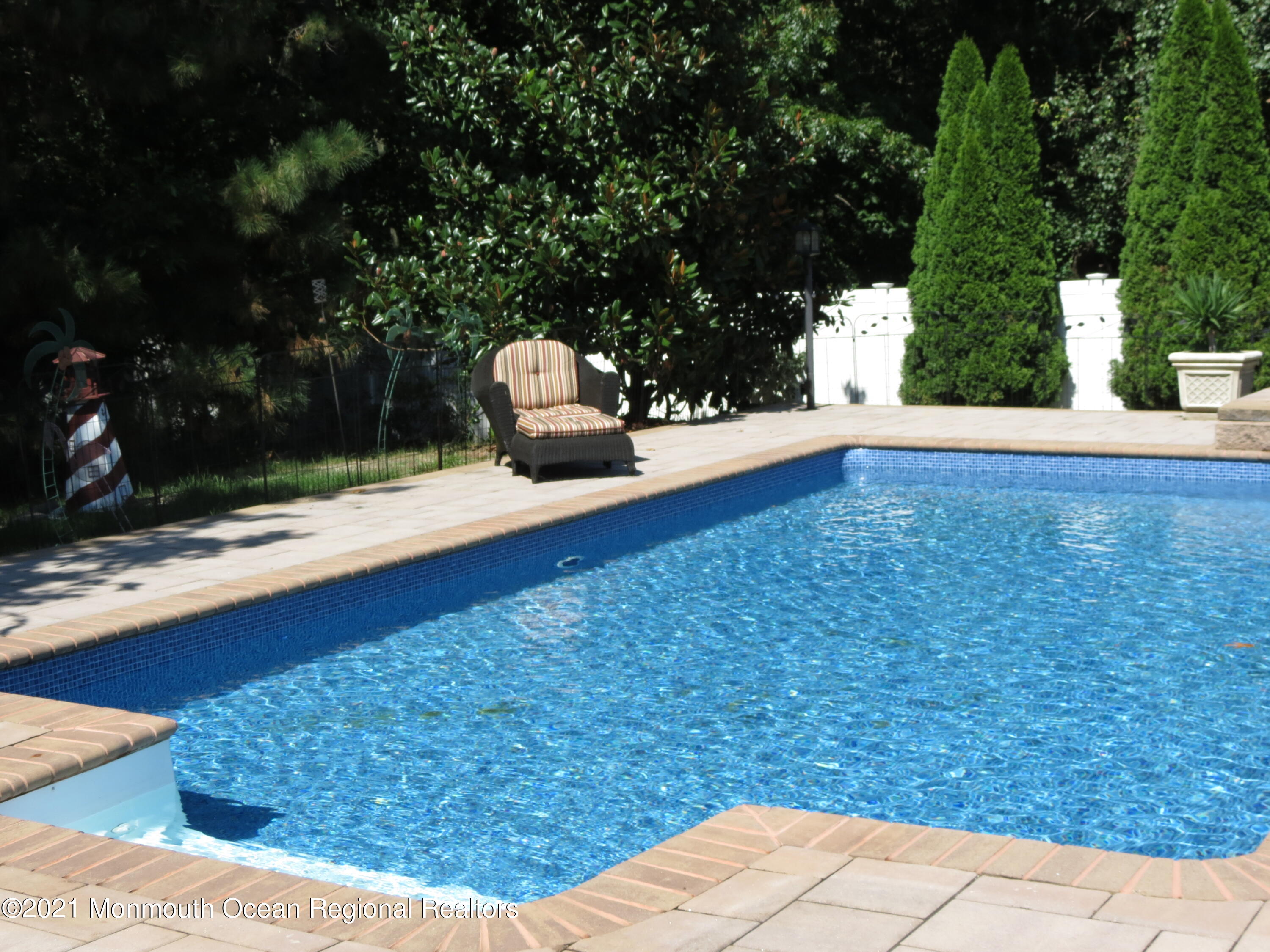 36 Woods Edge Drive Jackson, NJ 08527 - Photo 62 of 85 a wooden bench sitting in the backyard of a house