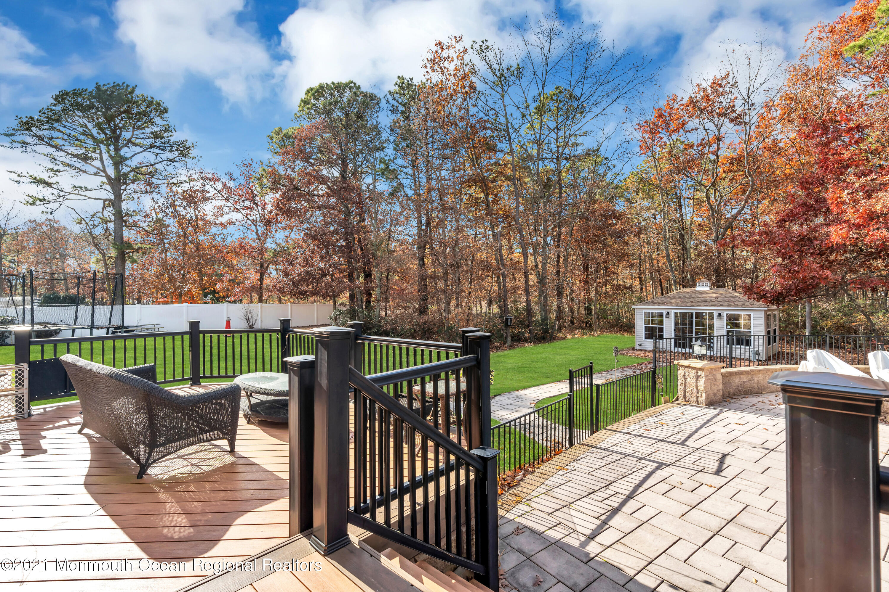 36 Woods Edge Drive Jackson, NJ 08527 - Photo 83 of 85 a view of a deck with couches table and chairs and wooden fence