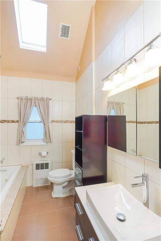 151 81st Street Brooklyn, NY 11209 - Photo 17 of 37 a bathroom with a sink toilet and shower