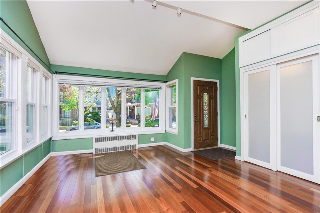 151 81st Street Brooklyn, NY 11209 - Photo 4 of 37 a view of an empty room with wooden floor and a window