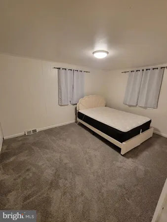 a spacious bedroom with a bed and a table in it