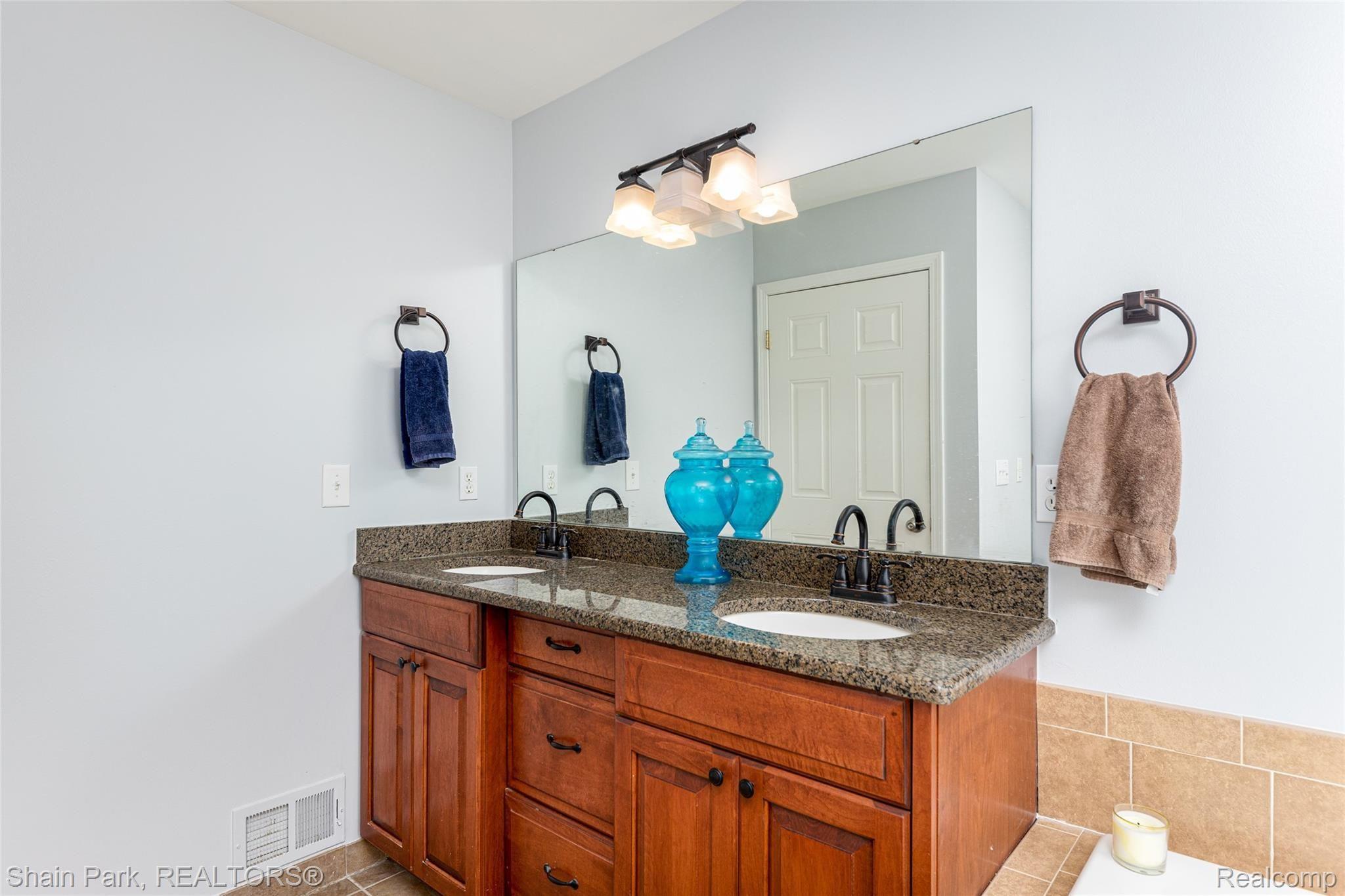 196 Londonderry Lane Rochester, MI 48306 - Photo 27 of 55 Master Bathroom with dual sinks, granite and countertop height Lafata cabinets