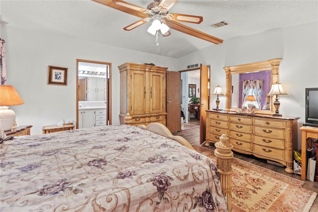 83 Eagle Circle Ellenton, FL 34222 - Photo 26 of 60 a bedroom with a bed and wooden floor