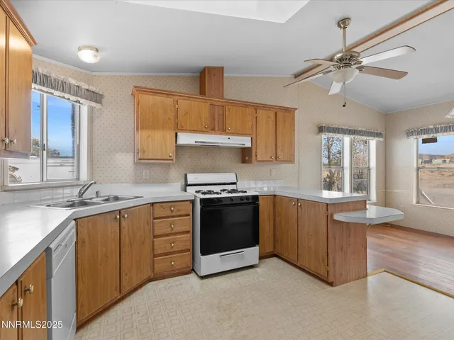 a kitchen with stainless steel appliances granite countertop a sink and stove