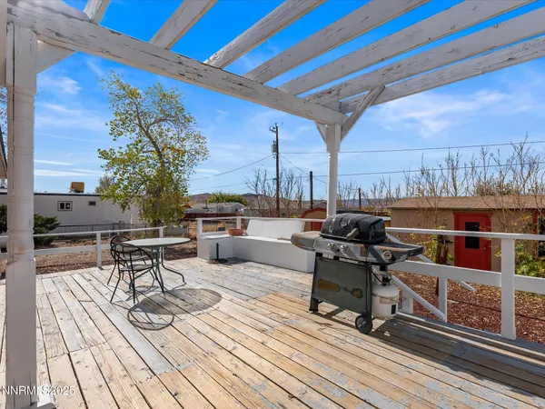 a roof deck with outdoor seating and city view