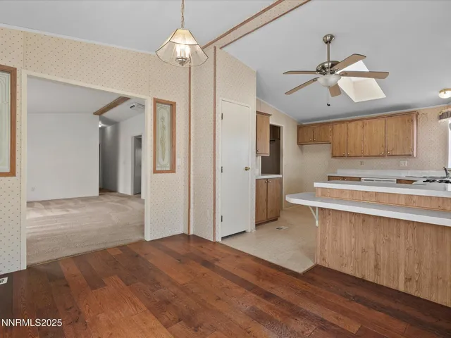a view of kitchen with granite countertop cabinets and refrigerator