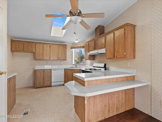 a kitchen with a stove a sink a refrigerator and cabinets