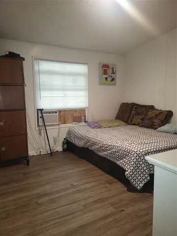 a living room with furniture a window and a flat screen tv