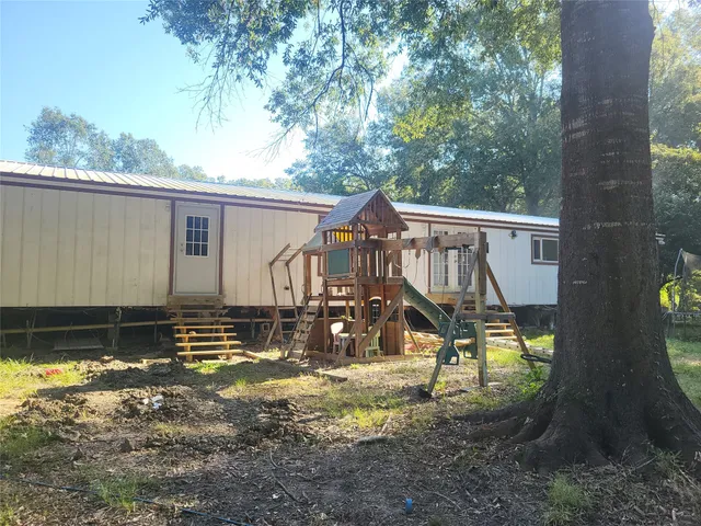 a backyard of a house with yard and outdoor seating