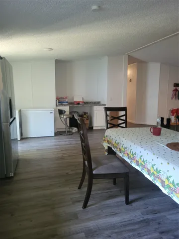 a view of an empty room and wooden floor