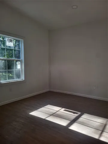 a view of a big yard with swimming pool and large trees