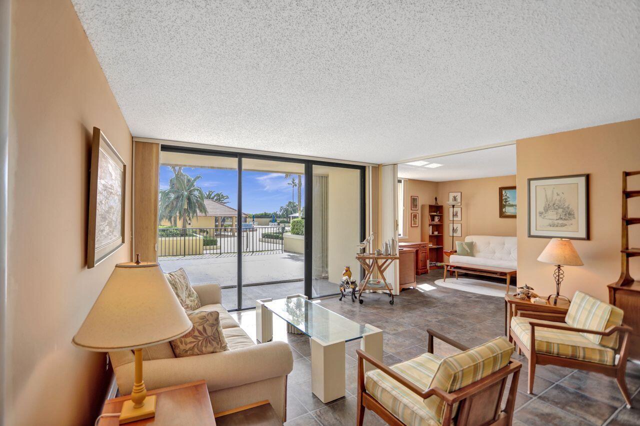 100 Ocean Trail Way, Unit 109 Jupiter, FL 33477 - Photo 3 of 27 a living room with furniture and a large window