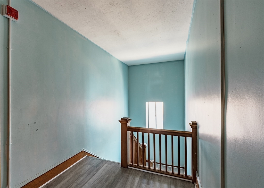 202-212 Pearl Street Springfield, MA 01105 - Photo 16 of 42 a view of a hallway with wooden floor