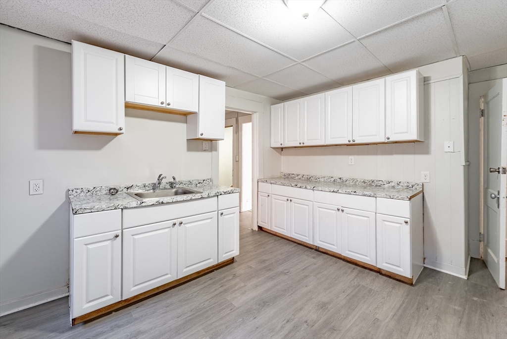 202-212 Pearl Street Springfield, MA 01105 - Photo 26 of 42 a kitchen with granite countertop white cabinets and white appliances