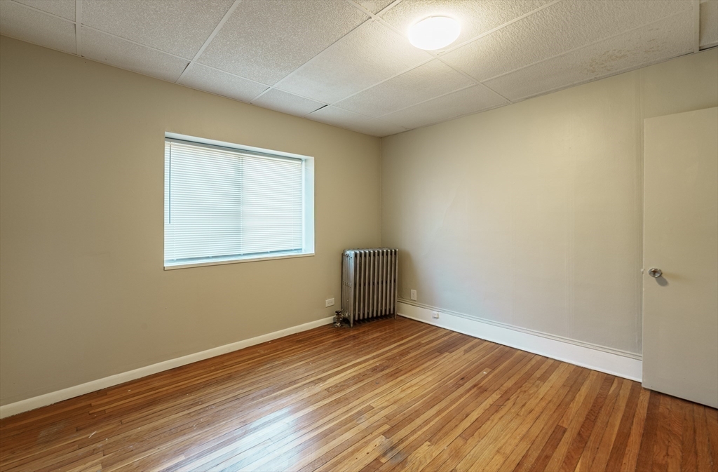 202-212 Pearl Street Springfield, MA 01105 - Photo 29 of 42 an empty room with wooden floor and windows