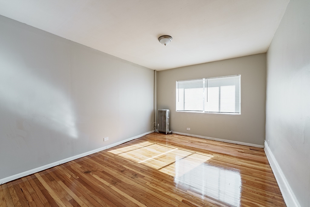 202-212 Pearl Street Springfield, MA 01105 - Photo 33 of 42 a view of an empty room with wooden floor and a window