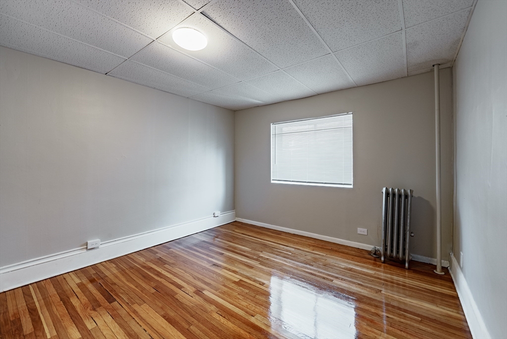 202-212 Pearl Street Springfield, MA 01105 - Photo 37 of 42 an empty room with wooden floor and windows