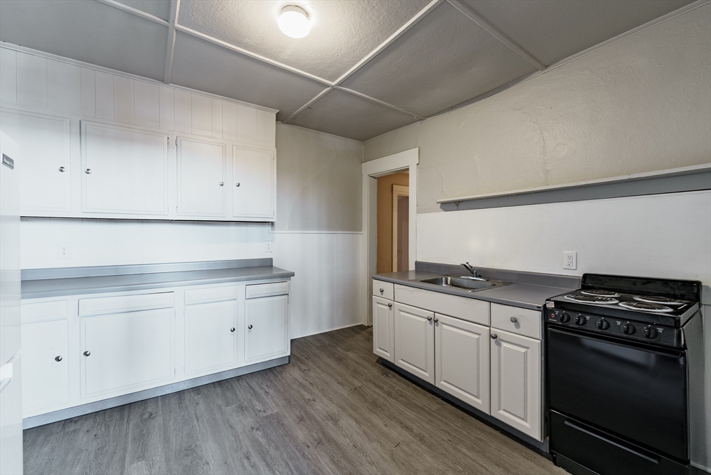 202-212 Pearl Street Springfield, MA 01105 - Photo 8 of 42 a kitchen with granite countertop a stove and a sink
