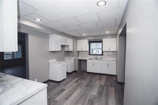a kitchen with a white wooden cabinets and white appliances