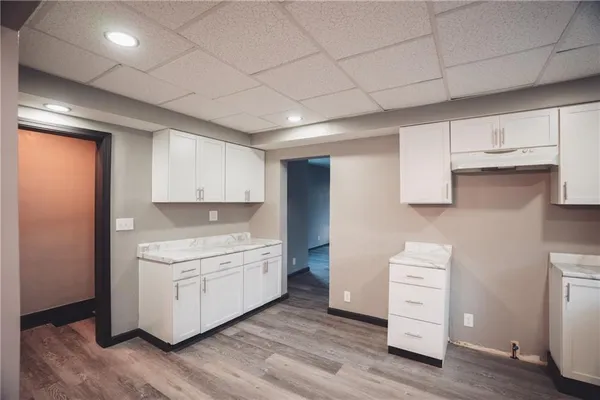 a kitchen with stainless steel appliances a stove and cabinets