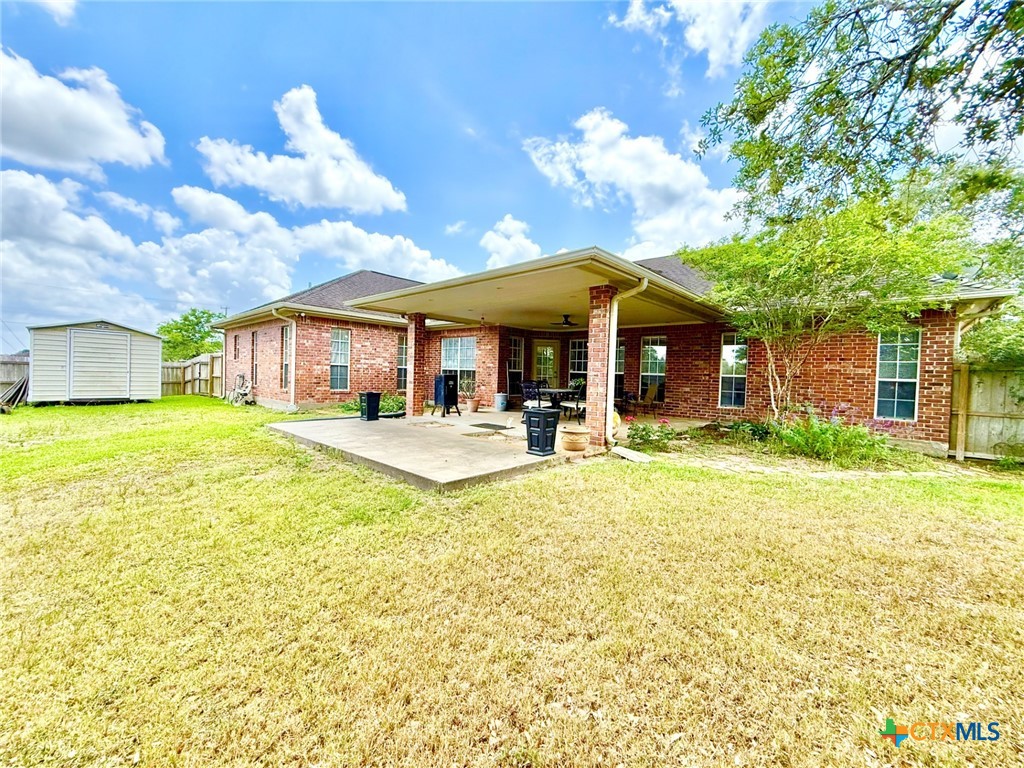 415 South Trinity Street Edna, TX 77957 - Photo 41 of 46 a view of a white house with a large pool and a yard