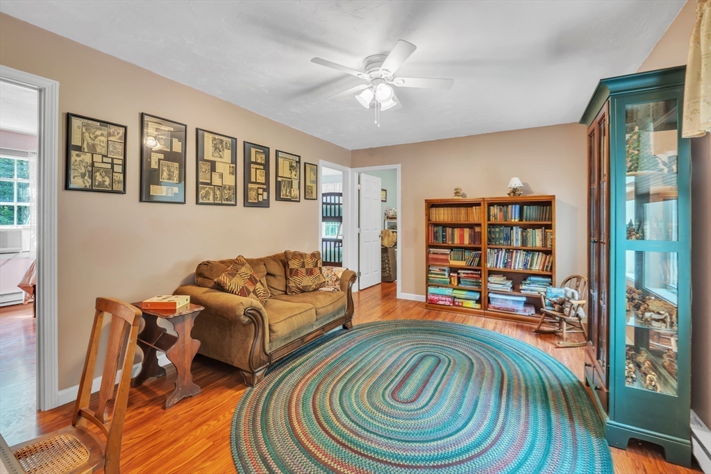 44 Buffum Road Charlton, MA 01507 - Photo 16 of 37 a living room with furniture and a bookshelf