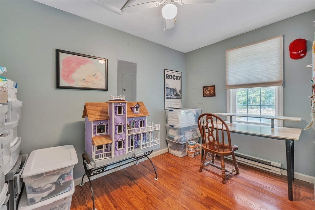 44 Buffum Road Charlton, MA 01507 - Photo 18 of 37 a work room with furniture and a bookshelf