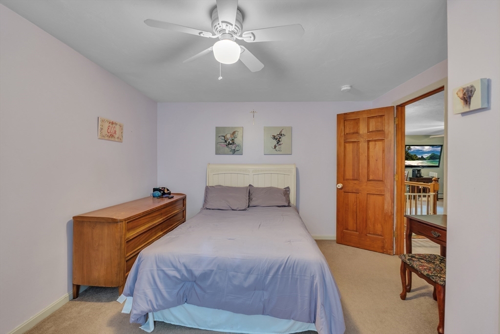 44 Buffum Road Charlton, MA 01507 - Photo 25 of 37 a bedroom with a bed and a chandelier