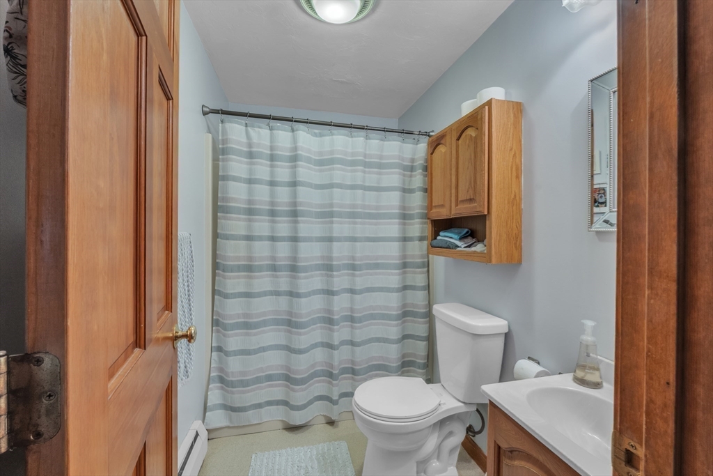44 Buffum Road Charlton, MA 01507 - Photo 30 of 37 a bathroom with a toilet and a shower curtain