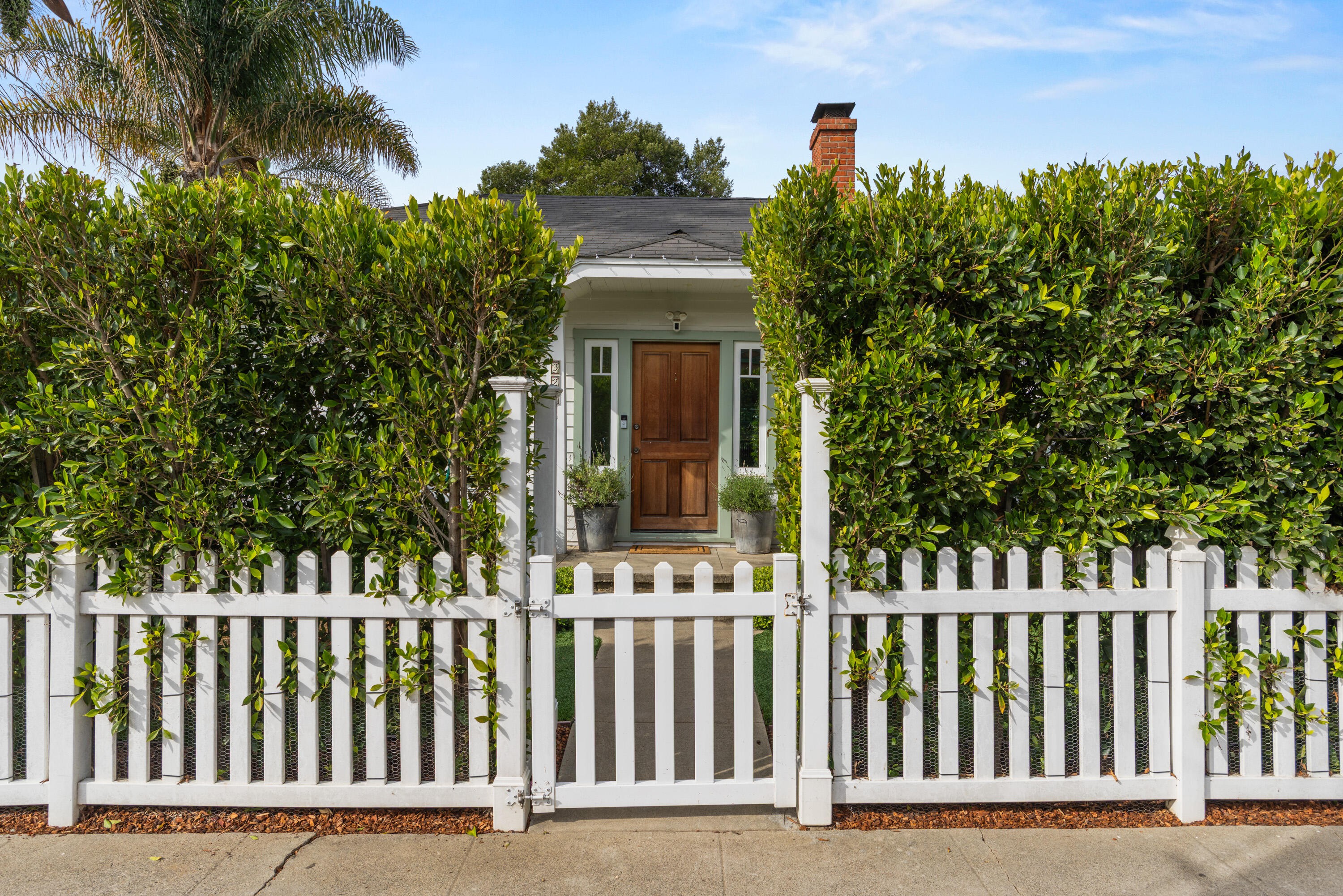 a front view of a house with a garden