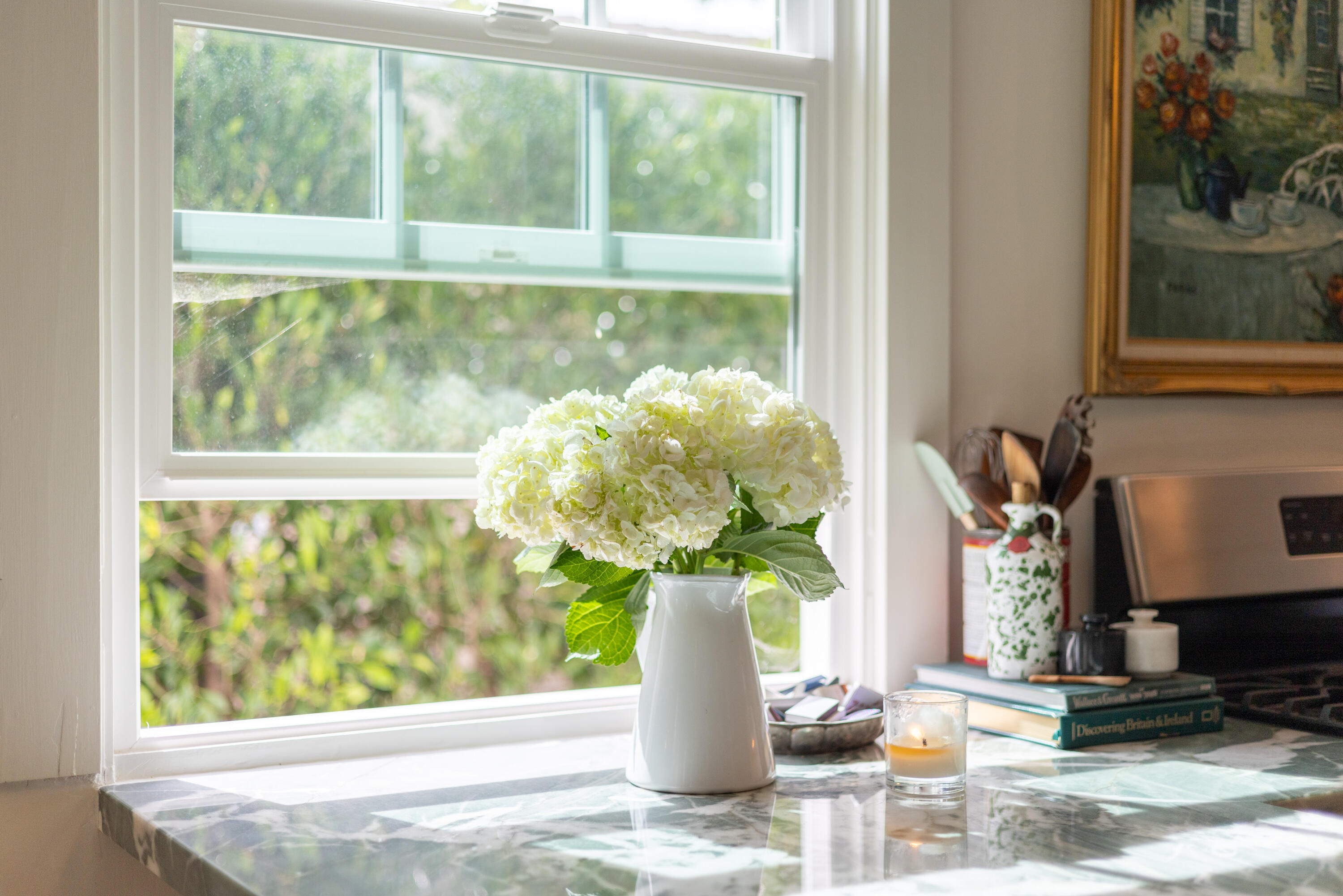 321 North Soledad Street Santa Barbara, CA 93103 - Photo 10 of 25 a vase of flowers sitting on a table with a potted plant