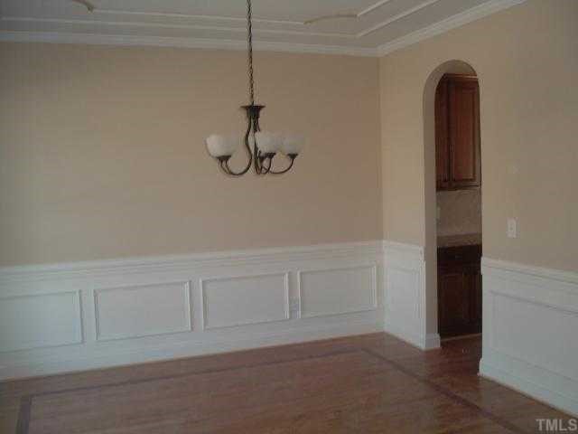 5820 Spring Glen Lane Raleigh, NC 27616 - Photo 3 of 12 Formal Dining Room w/ Arched openings, Elegant Cherry Inlay & 3/4" Tongue & Groove Site Finished Solid Oak Hardwoods also in Entry Foyer, and Powder Room. Crown Molding on entire first floor. Butler's Pantry off Dining Room.