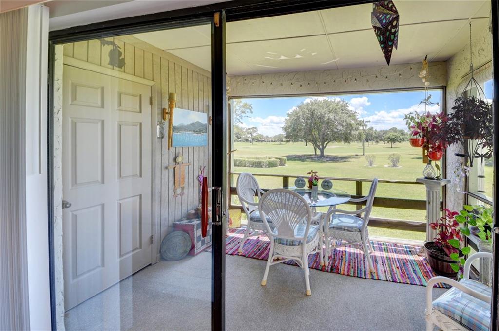 5433 Southeast Miles Grant Road, Unit E203 Stuart, FL 34997 - Photo 20 of 42 a view of a dining room with furniture window and outside view
