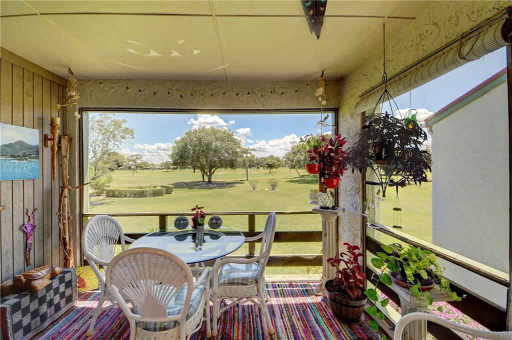 5433 Southeast Miles Grant Road, Unit E203 Stuart, FL 34997 - Photo 21 of 42 a view of a dining room with furniture window and outside view