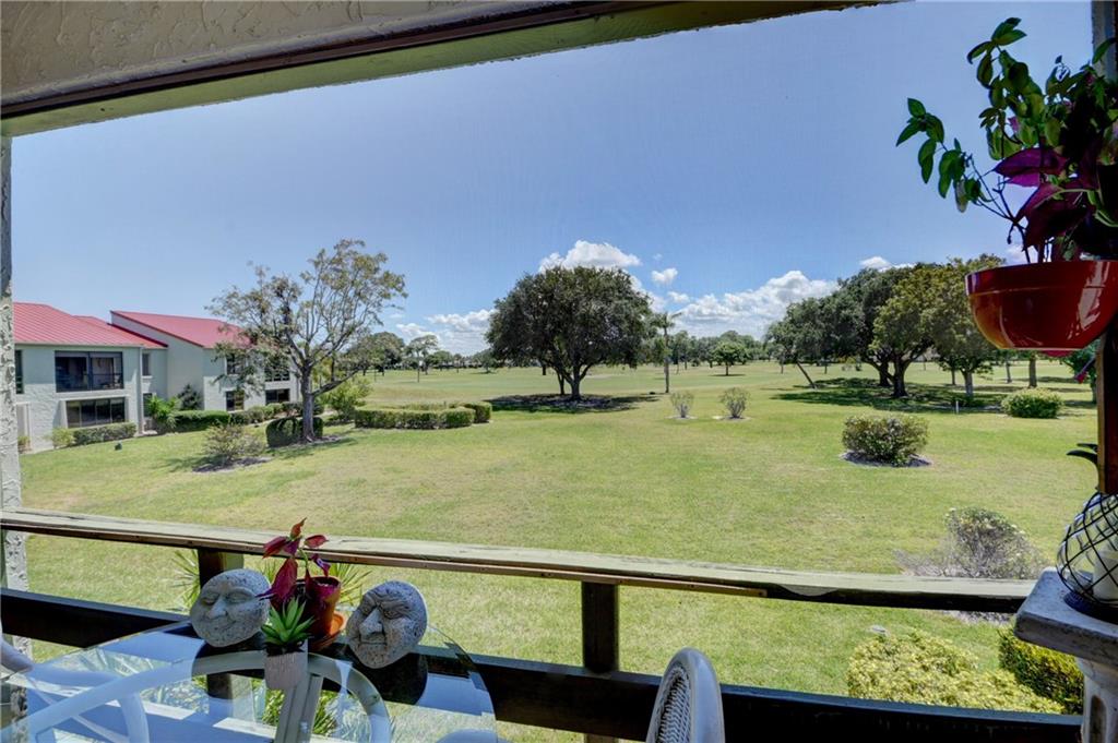 5433 Southeast Miles Grant Road, Unit E203 Stuart, FL 34997 - Photo 24 of 42 a view of a lake with a outdoor space
