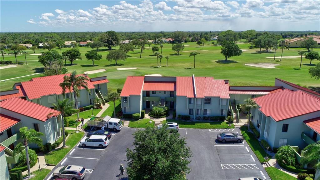 5433 Southeast Miles Grant Road, Unit E203 Stuart, FL 34997 - Photo 28 of 42 a view of a swimming pool and outdoor space