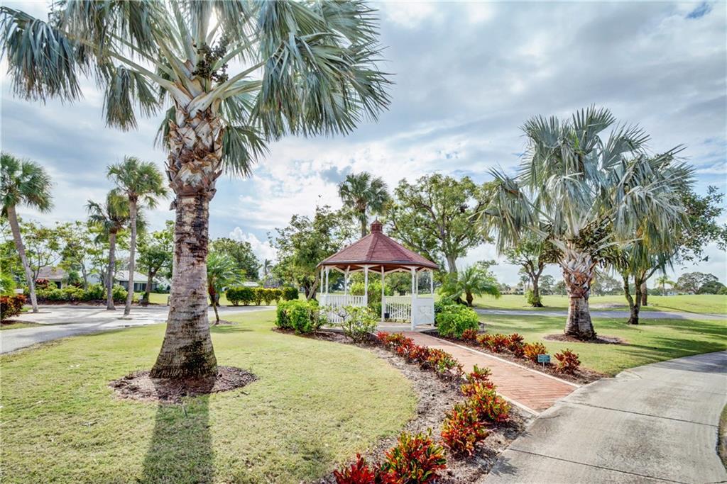 5433 Southeast Miles Grant Road, Unit E203 Stuart, FL 34997 - Photo 39 of 42 a front view of a house with a yard