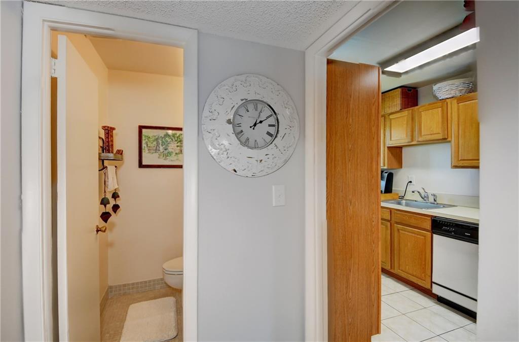 5433 Southeast Miles Grant Road, Unit E203 Stuart, FL 34997 - Photo 10 of 42 a view of bathroom with a toilet sink and mirror