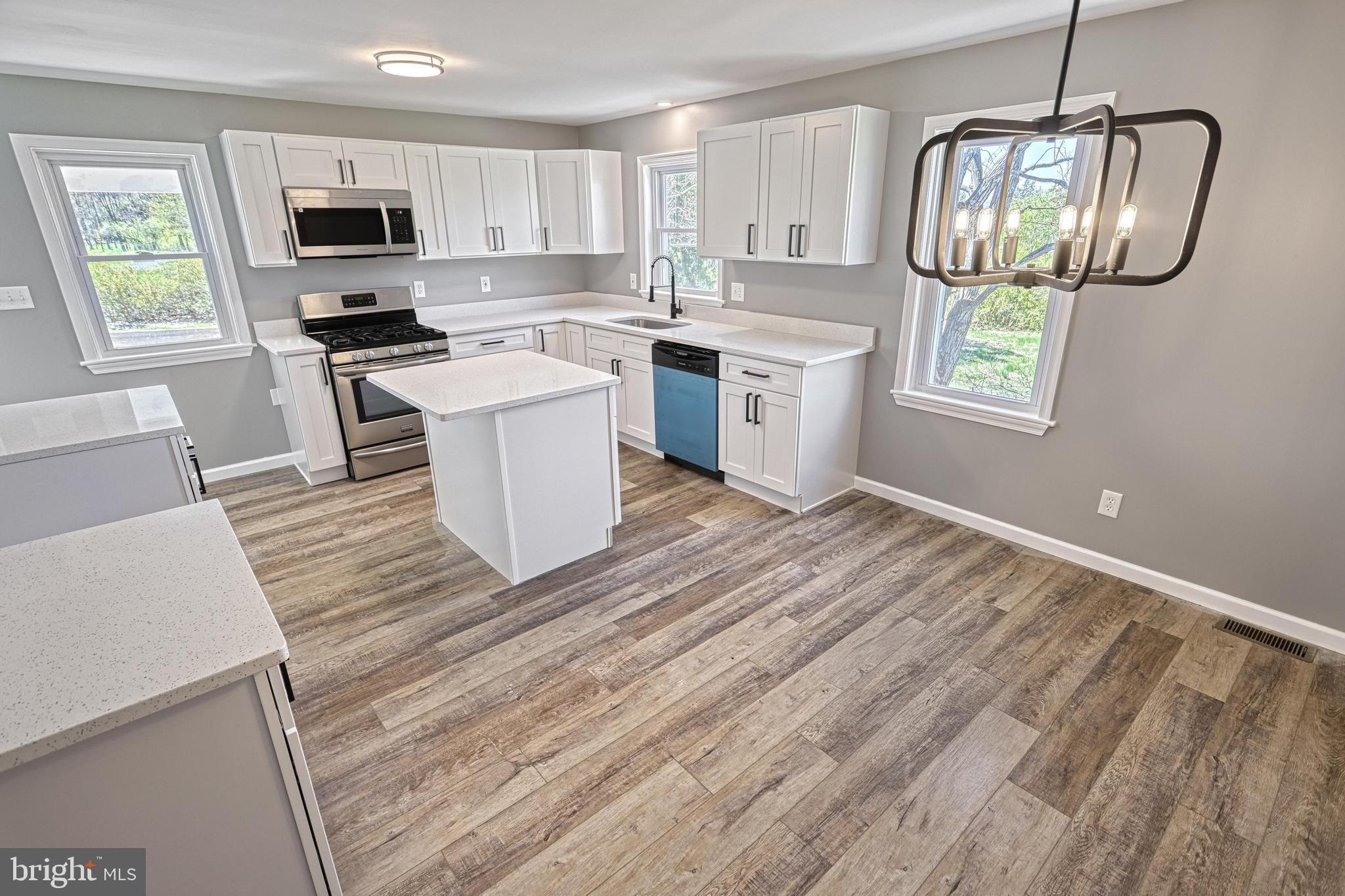 35 Herrs Ridge Road Gettysburg, PA 17325 - Photo 11 of 66 a kitchen with stainless steel appliances granite countertop a stove sink and microwave