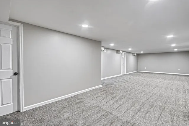 a picture of a bench in front of a wall