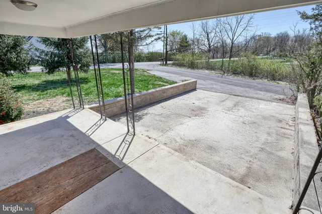 an aerial view of a houses with a yard and lake view