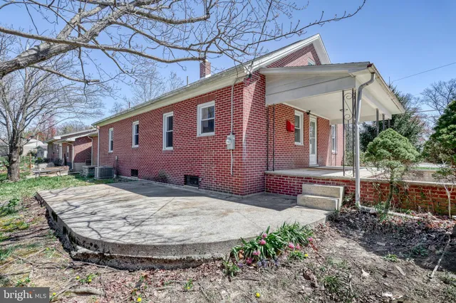 an aerial view of a houses with a yard and lake