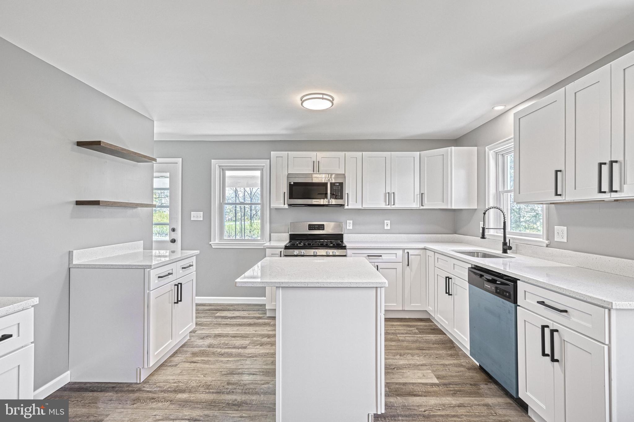 35 Herrs Ridge Road Gettysburg, PA 17325 - Photo 9 of 66 a kitchen with stainless steel appliances granite countertop a stove top oven a sink dishwasher and a refrigerator with wooden floor